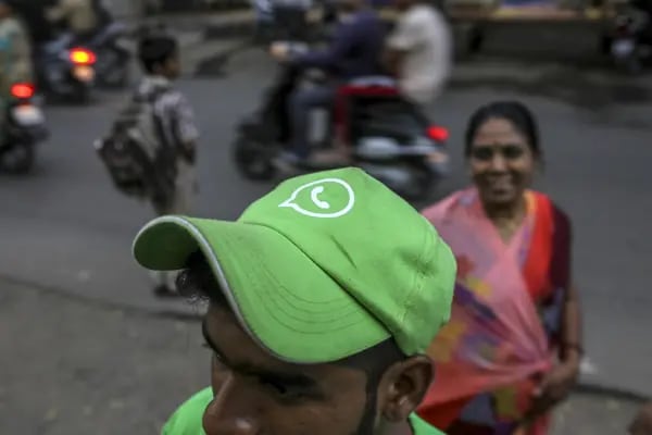A WhatsApp ambassador wears a branded cap during a roadshow for Facebook Inc.'s WhatsApp messaging service and Reliance Jio Infocomm Ltd.'s wireless network in Pune, India, on Thursday, Oct. 25, 2018. Facebook and Reliance Jio are teaming up to draw hordes of customers with cheap phones, rock-bottom rates and handy messaging services. Photographer: Dhiraj Singh/Bloomberg
