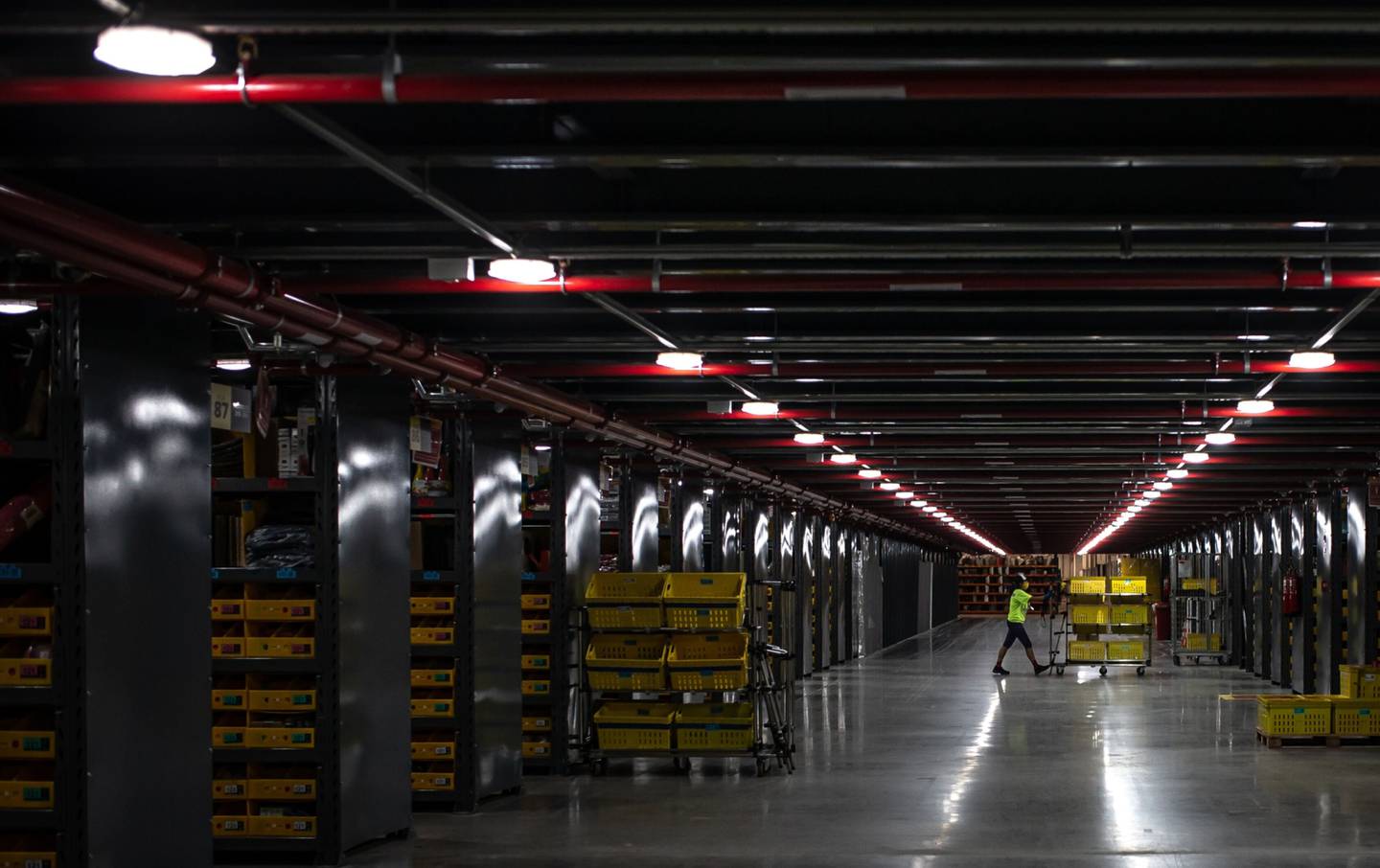 A worker pushes a cart at a MercadoLibre Inc. distribution and fulfillment center in Cajamar, Sao Paulo.