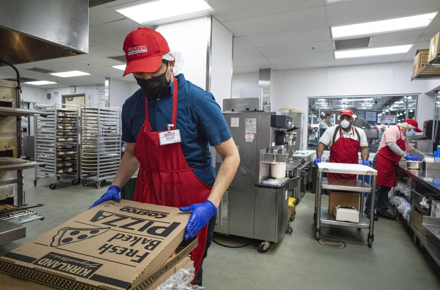 Un trabajador con una máscara protectora empaca una pizza dentro de una tienda de Costco en San Francisco, California, Estados Unidos, el miércoles 3 de marzo de 2021.