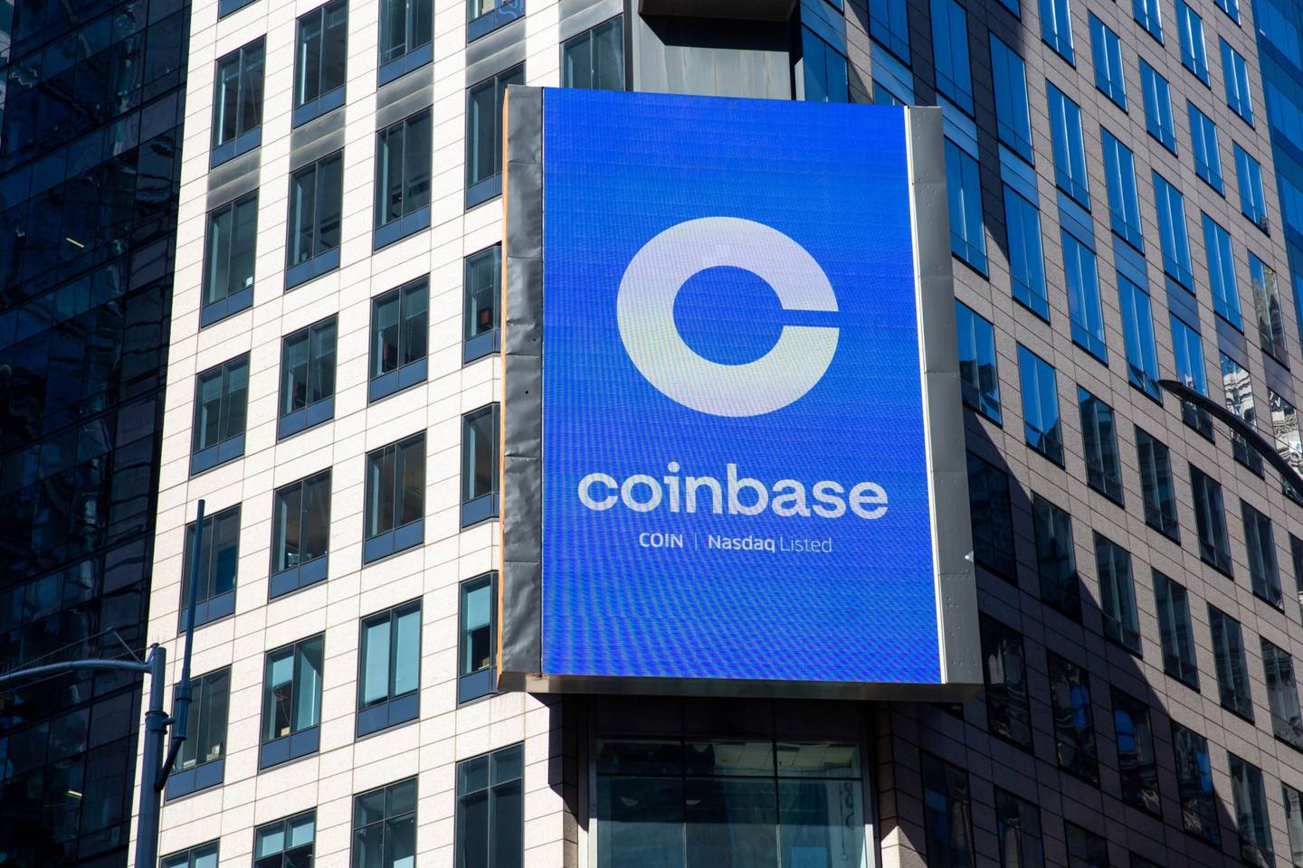 A monitor displays Coinbase signage during the company's initial public offering (IPO) at the Nasdaq MarketSite in New York, on April 14, 2021.