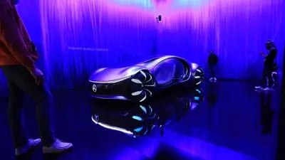 Visitors look at the Mercedes-Benz Vision AVTR concept vehicle.