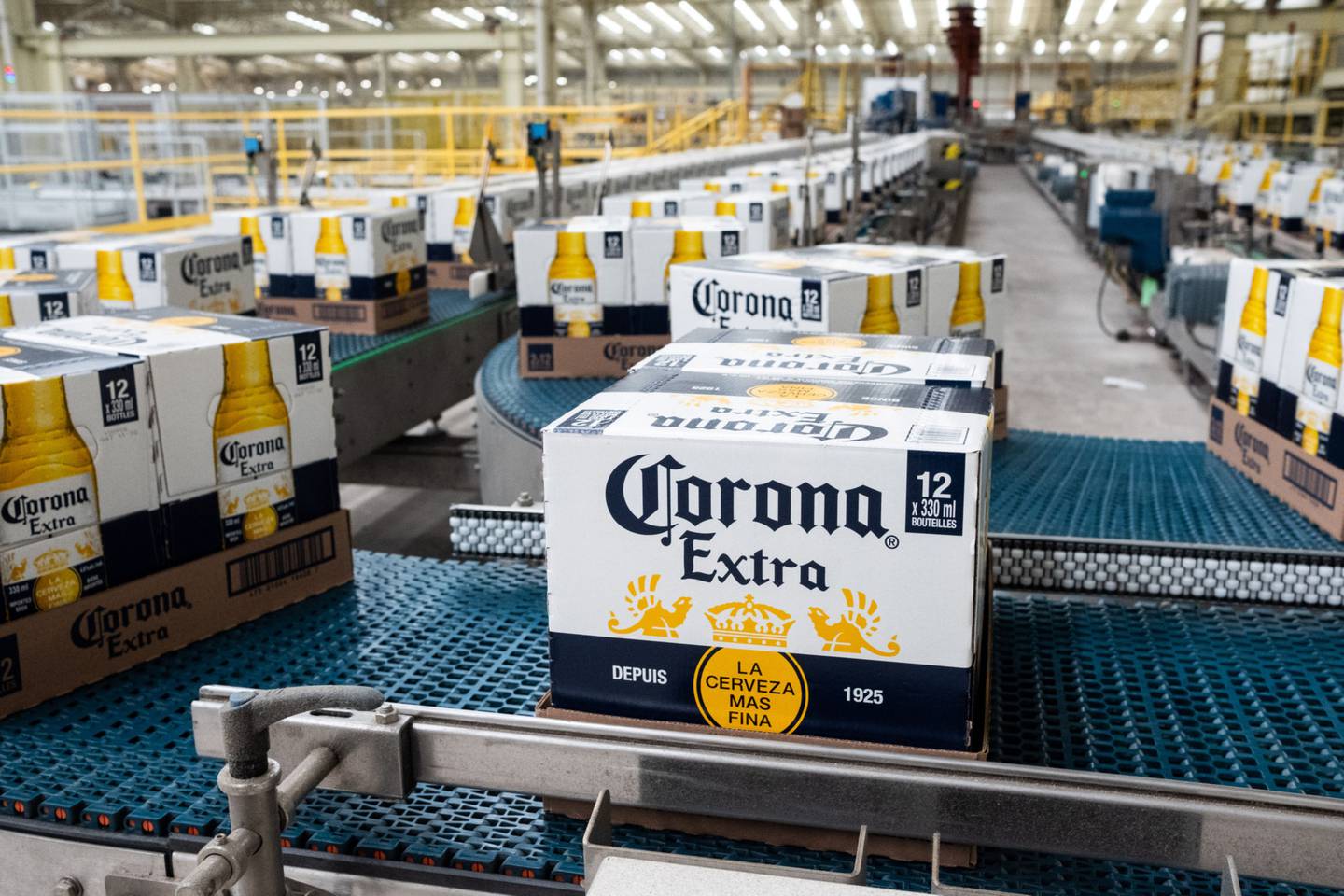 Boxes of Grupo Modelo SAB Corona brand beer move along a conveyor belt at the Cerveceria Yucateca Anheuser-Busch InBev SA facility in Merida, Mexico.
