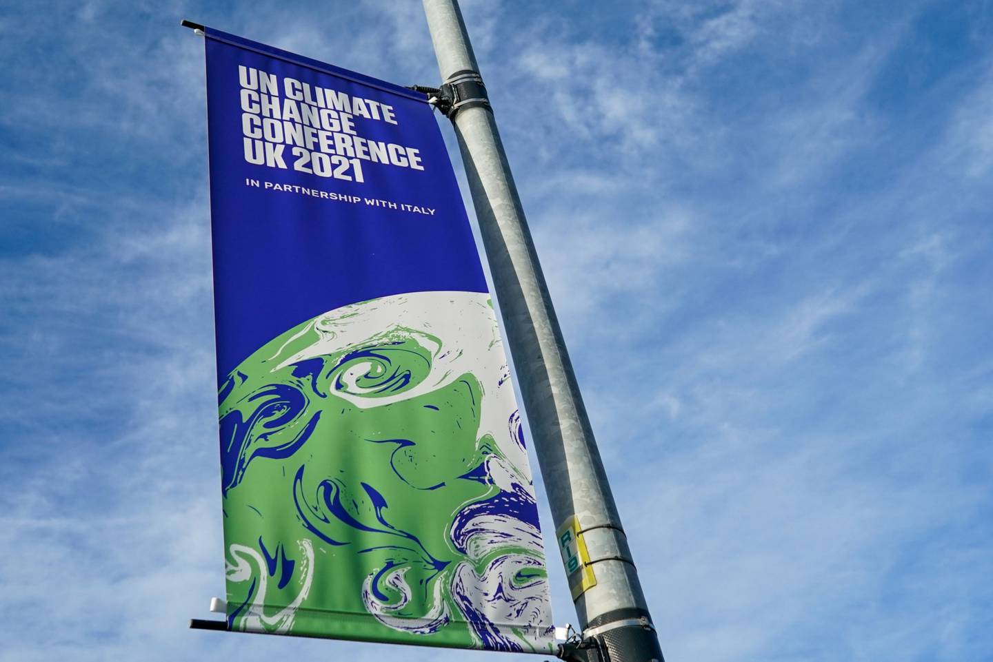 A banner advertisings the upcoming COP26 climate talks in Glasgow, U.K., on Wednesday, Oct. 20, 2021. Glasgow will welcome world leaders and thousands of attendees for the crucial United Nations summit on climate change in November.dfd