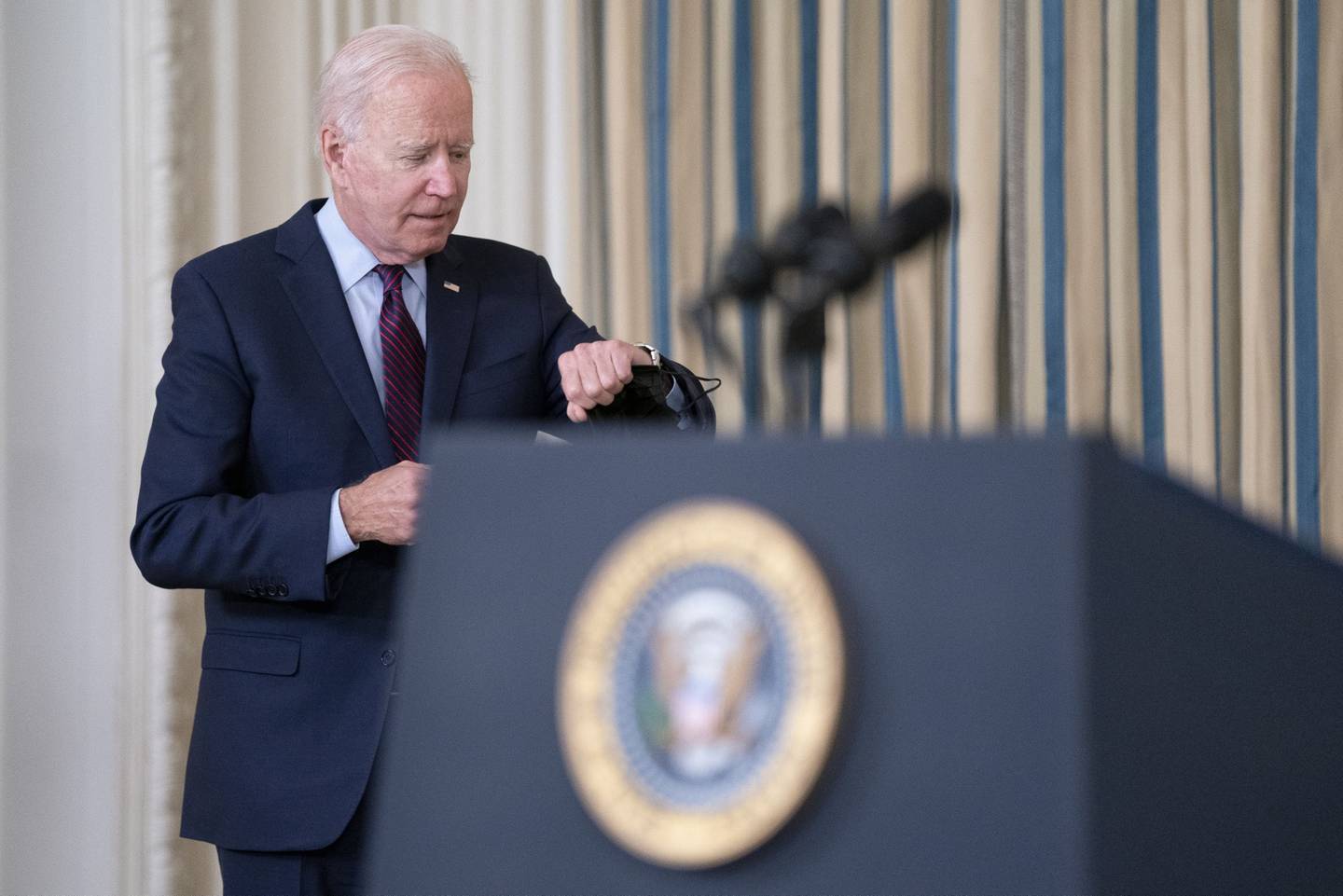 U.S. President Joe Biden checks his watch while arriving to speak in the State Dining Room of the White House in Washington, D.C., U.S., on Monday, Oct. 4, 2021. The U.S. is moving closer to its first-ever default, with neither political party in Washington yet signaling it's ready to back down from a partisan showdown on the federal debt limit. Photographer: Stefani Reynolds/Bloomberg 