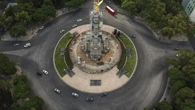 Vehicles travel along a nearly empty Reforma Avenue past the Angel of Independence monument in an aerial photograph taken over Mexico City.