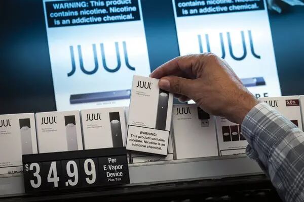 Un empleado recoge un kit de dispositivos Juul Labs Inc. para un cliente en una tienda en San Francisco, California, Estados Unidos, el miércoles 26 de junio de 2019. L