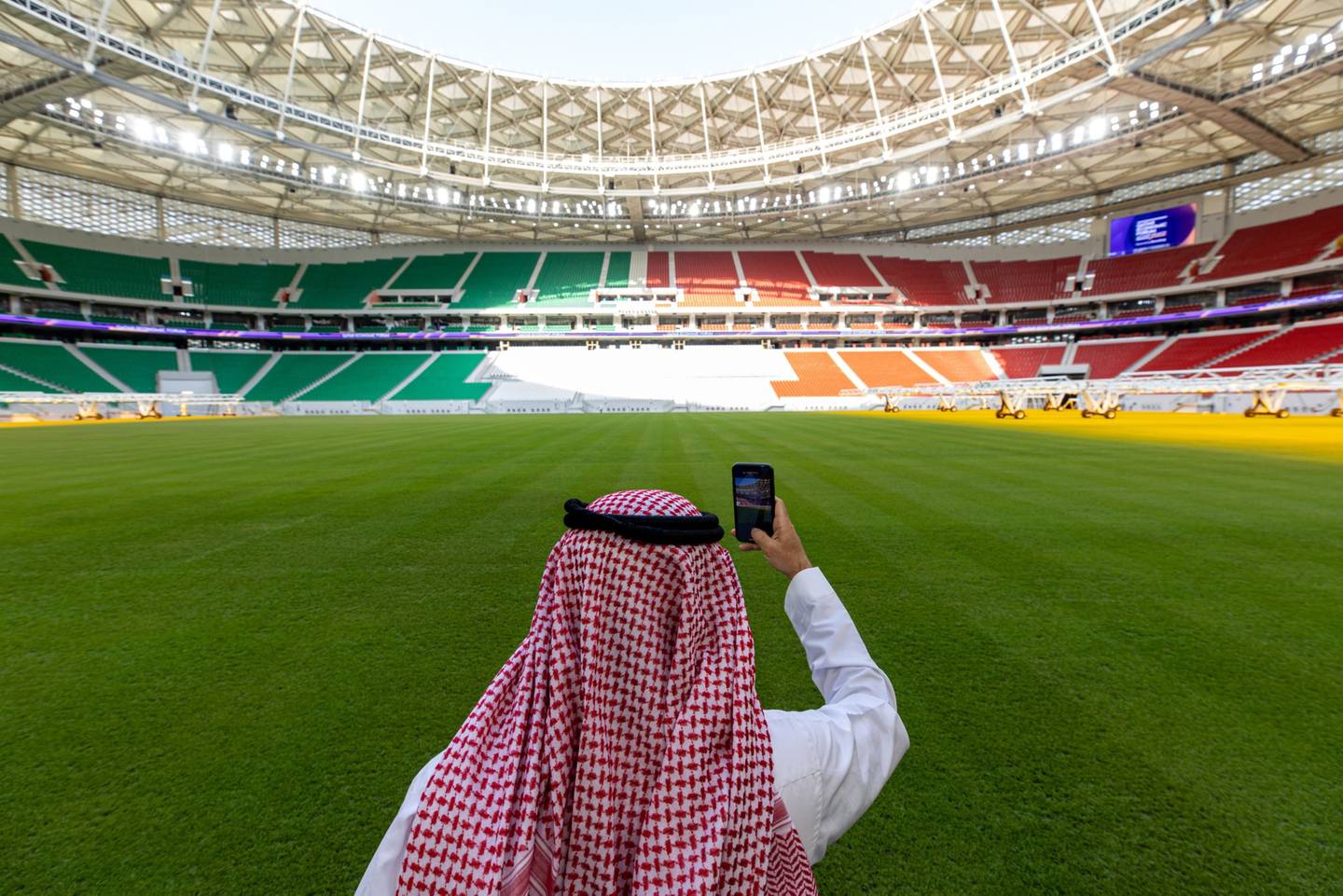 A visitor takes a smartphone photograph pitch side at the Al Thumama football stadium in Doha, Qatar.