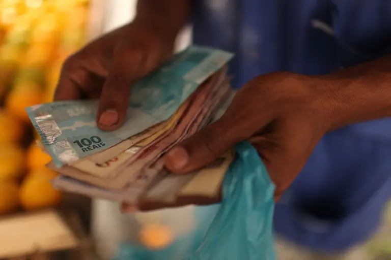 Un vendedor ambulante cuenta dinero en Río de Janeiro, Brasil, el jueves 31 de mayo de 2012. El real cayó por tercer día consecutivo un 0,3 por ciento a 2,0224 por dólar estadounidense.dfd