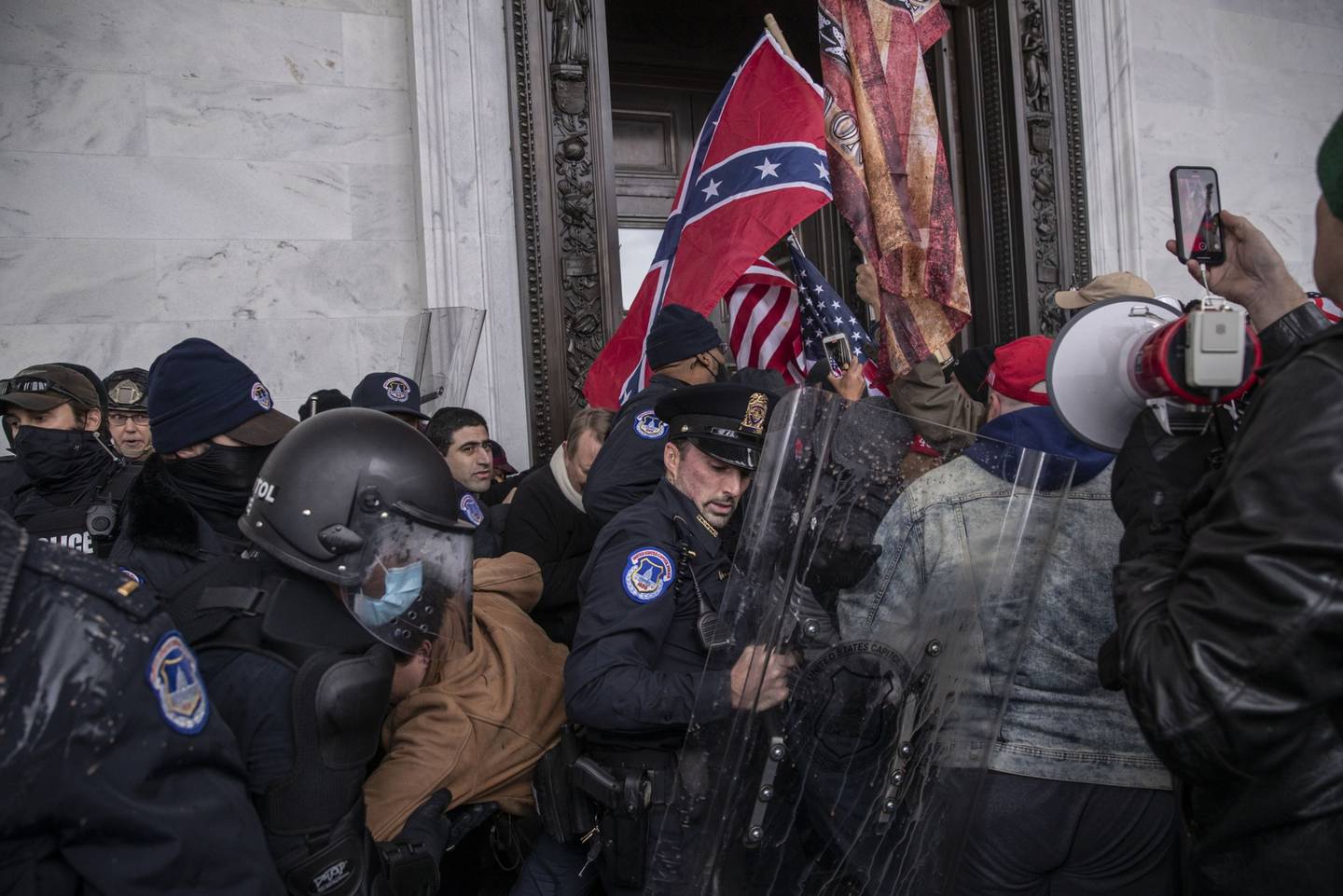 Demonstrators clash with U.S. Capitol police officers while trying to enter the Capitol building during a protest outside of in Washington, D.C., U.S., on Wednesday, Jan. 6, 2021.