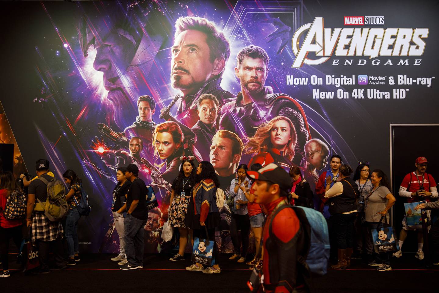 Attendees wait in line in front of a Marvel Studios Avengers Endgame poster during the D23 Expo 2019 in Anaheim, California, U.S., on Friday, Aug. 23, 2019. Walt Disney Co. is turning the D23 Expo, the biennial fan conclave, into a big push for its new streaming services. Photographer: Patrick T. Fallon/Bloomberg