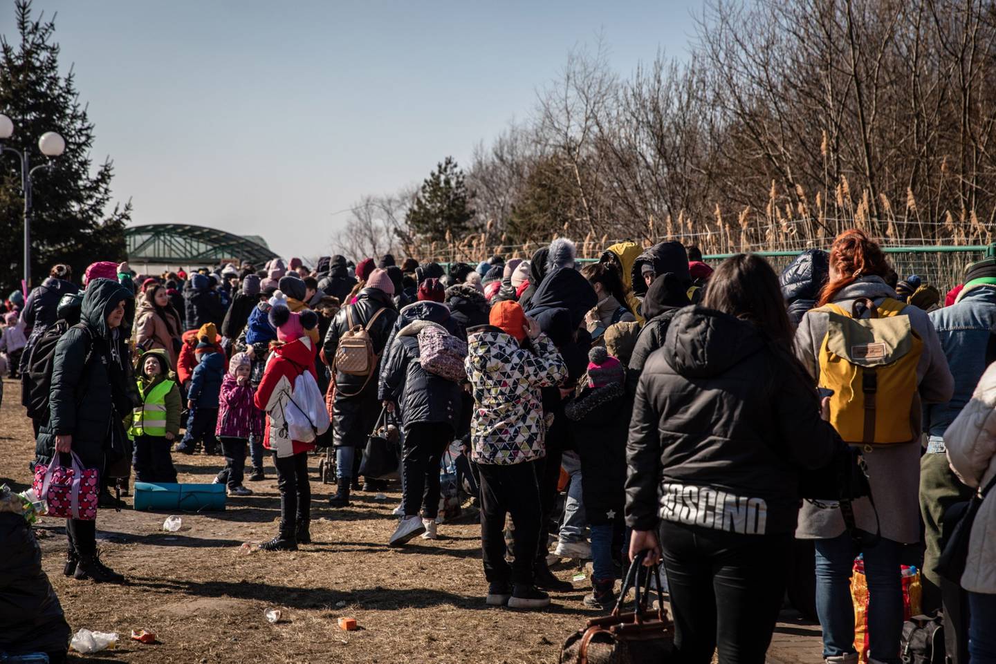 Ukrainian refugees queue to cross over into Poland via the Medyka border crossing in Shehyni, Ukraine, on Friday, March 18, 2022. The number of refugees reaching Poland from Ukraine now exceeds 2 million, mostly women with children, Polish border authorities said. Photographer: Angel Garcia/Bloombergdfd