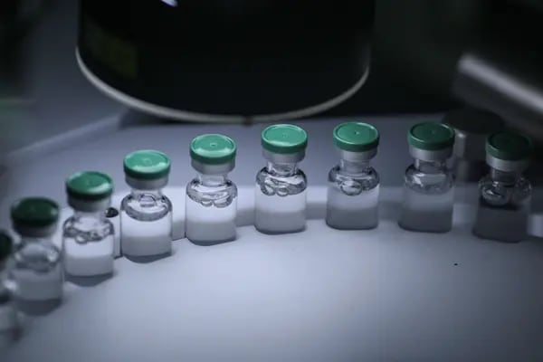 Glass vials of Covid-19 vaccine on the production line. Photographer: Dhiraj Singh/Bloomberg