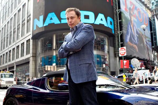 Elon Musk, chairman and chief executive officer of Tesla Motors, stands for a portrait with a Tesla Roadster outside the Nasdaq Marketsite in New York, U.S., on Tuesday, June 29, 2010