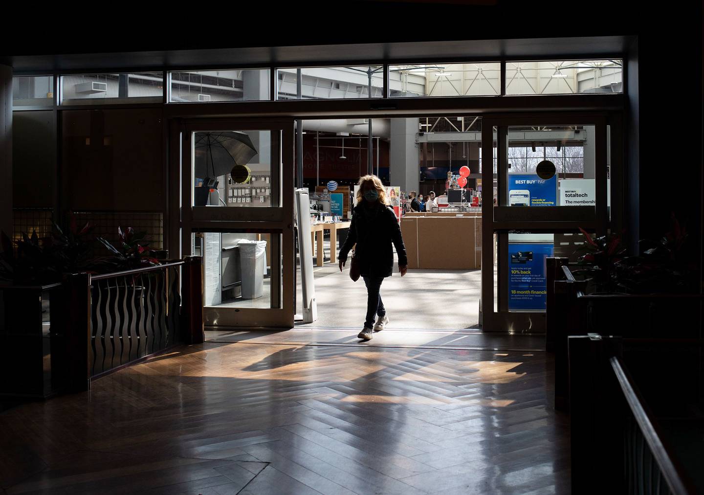 A shopper walks out of a store at the Southland Center shopping mall in Taylor, Michigan. Photographer: Emily Elconin/Bloomberg