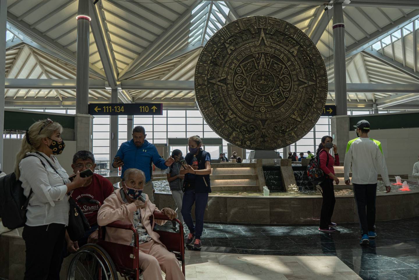 Visitors near a reproduction of the Aztec Sun Stone calendar at Felipe Angeles International Airport (AIFA) in Zumpango, Mexico, on Sunday, March 13, 2022.  Felipe Angeles International Airport is expected to open on March 21.