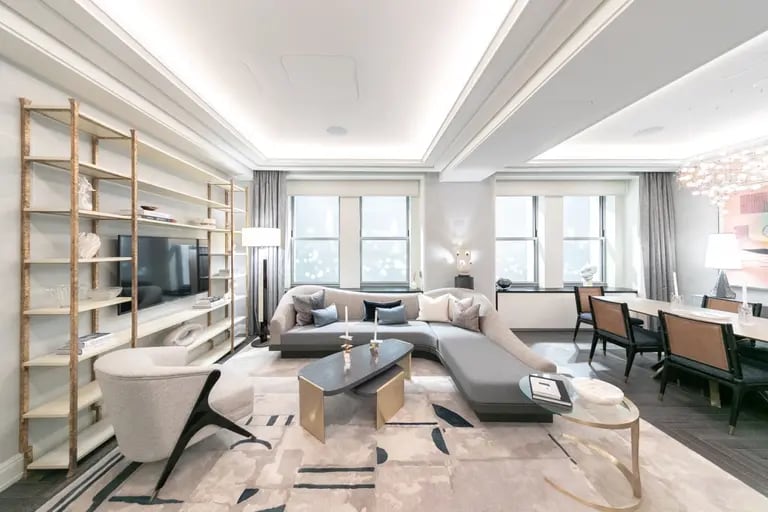 The living and dining room of a model apartment at the Towers of the Waldorf Astoria sales office. Photographer: Jeenah Moon/Bloombergdfd