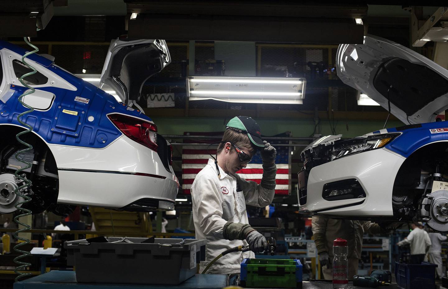A production associate adjusts his hat while working between 2018 Honda Accord vehicles during production at the Honda of America Manufacturing Inc. Marysville Auto Plant in Marysville, Ohio, U.S.Photographer: Ty Wright/Bloomberg