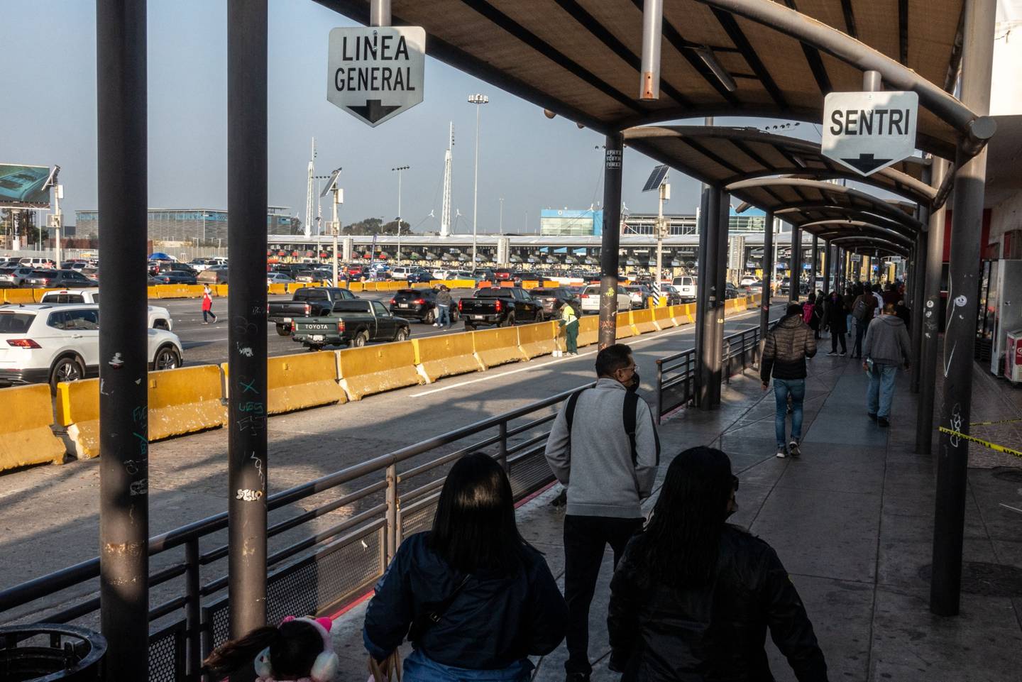 Pedestrians cross the San Ysidro Port of Entry towards San Diego, U.S., in Tijuana, Mexico, on Monday, Nov. 8, 2021.