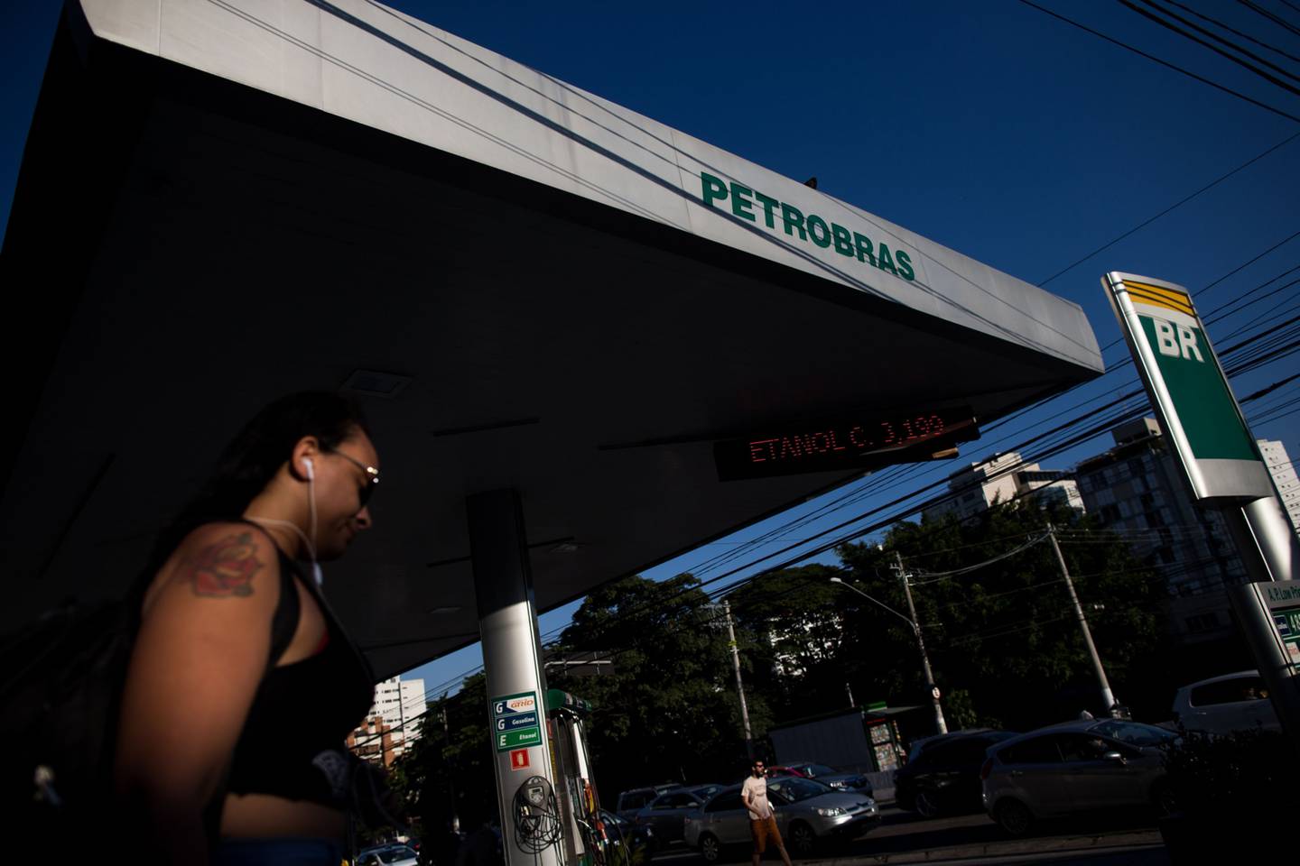 A pedestrian walks past a Petroleos Brasileiros SA (Petrobras) gas station in Sao Paulo.