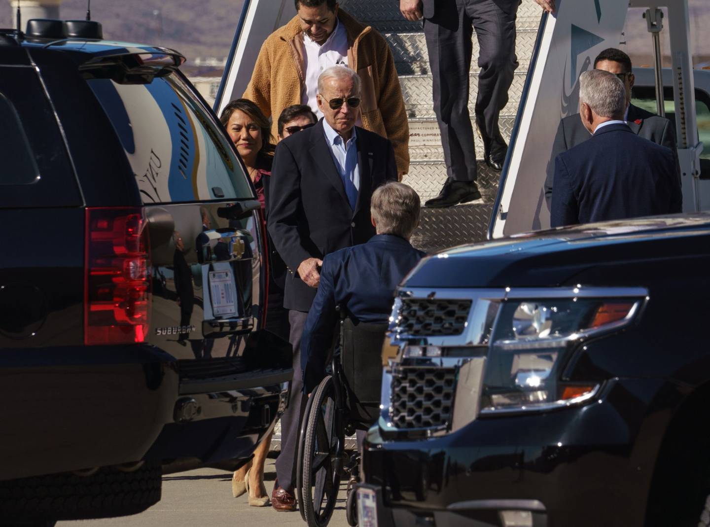 US President Joe Biden center, greets Greg Abbott, governor of Texas, at El Paso International Airport in El Paso, Texas, US, on Sunday, Jan. 8, 2023. Biden will see first-hand conditions for migrants and the US officials who process them as they cross from Mexico during his first presidential visit to the US and Mexico border. Photographer: Paul Ratje/Bloombergdfd