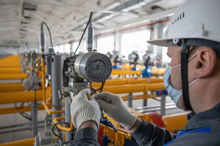 A worker installs new gas flow monitoring equipment inside a gas collect point of the Kasimovskoye underground gas storage facility, operated by Gazprom PJSC, in Kasimov, Russia, on Wednesday, Nov. 17, 2021. Russia signaled it has little appetite for increasing the natural gas it transits through other territories to Europe as the winter heating season gets underway. Photographer: Andrey Rudakov/Bloombergdfd