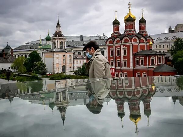 Un hombre camina junto a las catedrales ortodoxas rusas en el parque Zaryadye de Moscú. Fotógrafo: Yuri Kadobnov/AFP/Getty Images