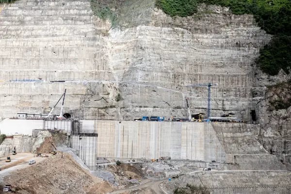Trucks drives through the Hidroituango hydroelectric dam construction site in the town of Ituango, Antioquia Department, Colombia, on Sunday, May 20, 2018. A worsening crisis at an unfinished $4 billion dam in northwest Colombia is causing widespread flooding, displacing thousands of residents and threatening the largest hydroelectric project ever undertaken in the South American country. Photographer: Tomas Ayuso/Bloomberg
