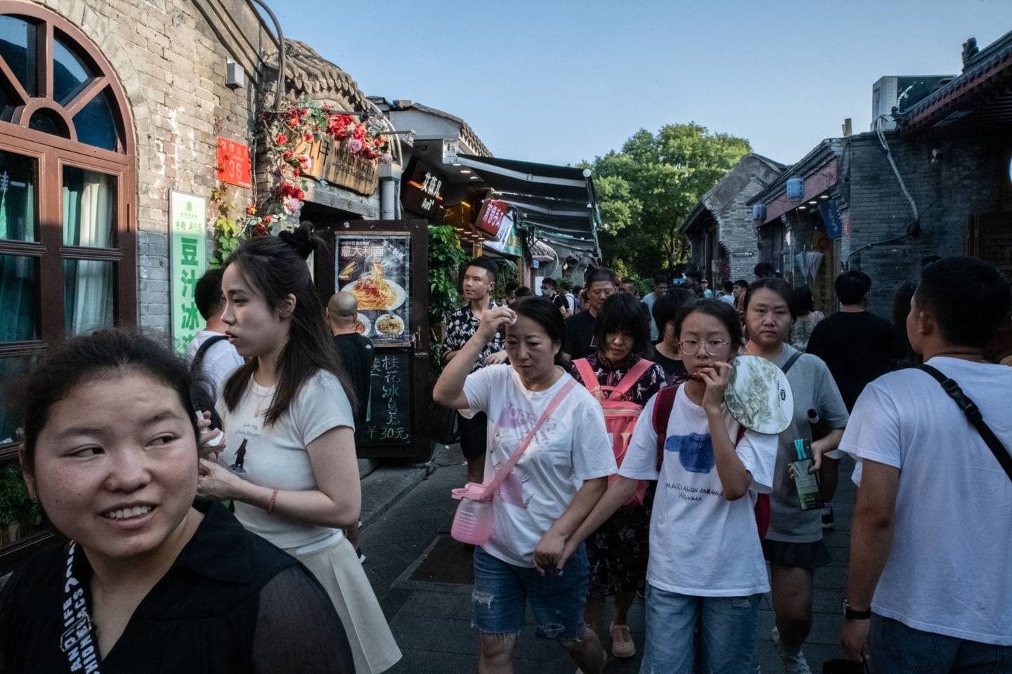 Visitors in Nanluoguxiang, an alleyway popular with tourists, in Beijing. Source: Bloombergdfd