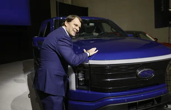Ford CEO Jim Farley with an F-150 Lightning.