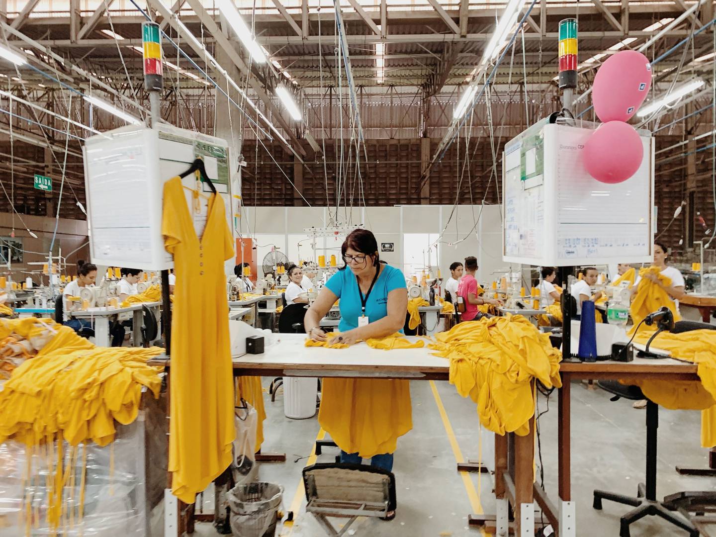 An employee sews dresses at the Guararapes Confeccoes SA textile factory in Natal, Rio Grande do Norte, Brazil.