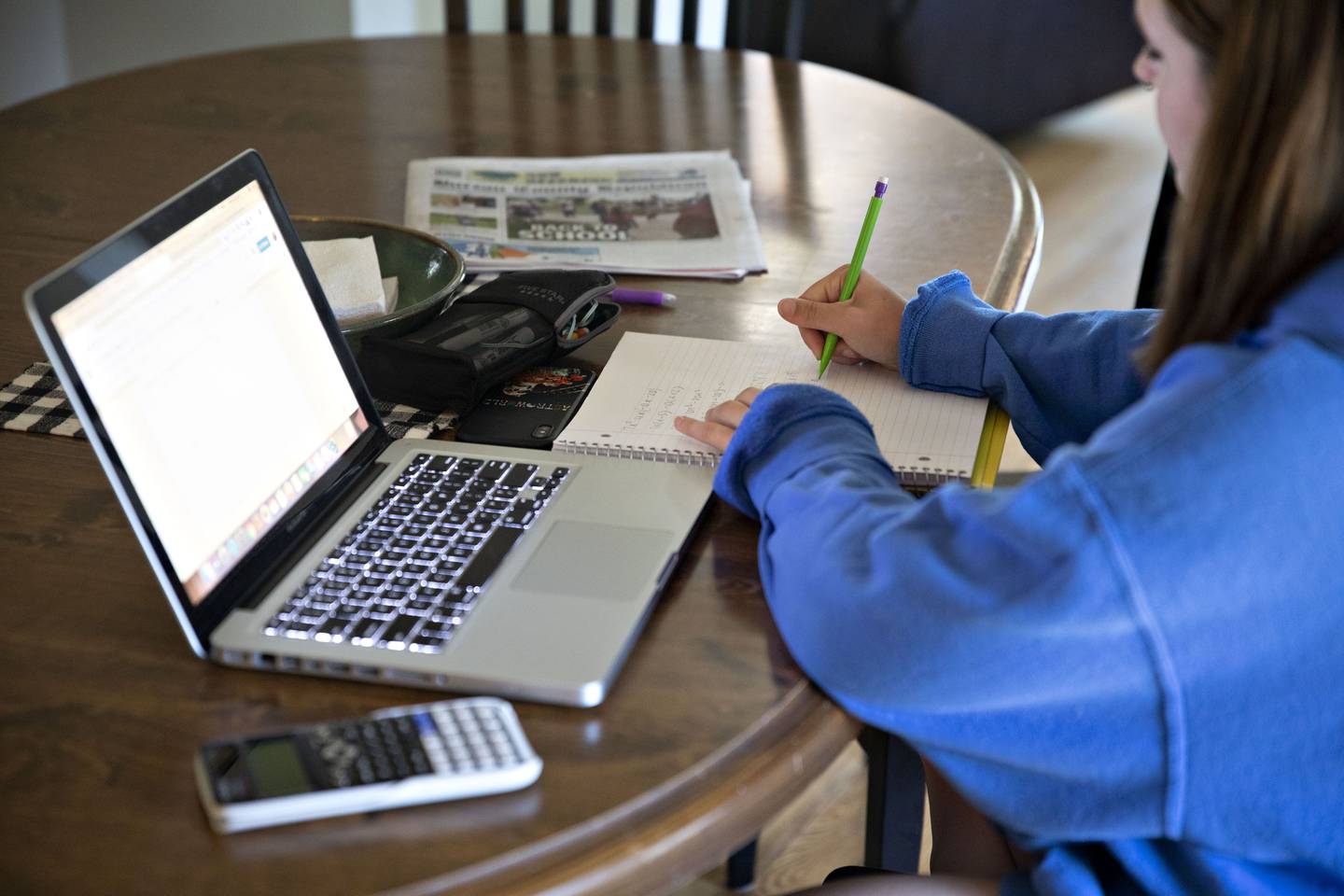 A high school student works on an assignment on a laptop computer at home during a remote learning day in Tiskilwa, Illinois, U.S., on Wednesday, Aug. 19, 2020. Illinois reported 1,337 new coronavirus cases Wednesday as the state's positivity rate dropped below 4% for the first time in weeks. Photographer: Daniel Acker/Bloomberg