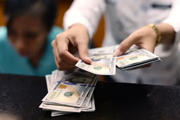 Un empleado cuenta billetes de 100 dólares estadounidenses en una oficina de cambio de moneda en Yakarta, Indonesia, el lunes 7 de julio de 2014.