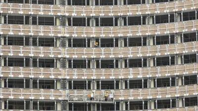 Construction workers operate on a platform at a hotel renovation project in Shanghai, China.