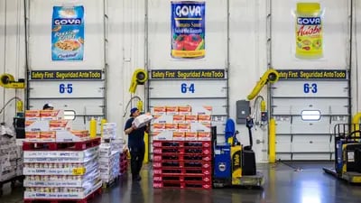 An employee stacks boxes of Goya Foods Inc. seasoning products on top of pallets at the company's distribution warehouse in Jersey City, New Jersey.
