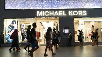 People line up outside the Michael Kors store on Orchard Road in Singapore, on Saturday, July 25, 2020. Singapores economy plunged into recession last quarter as an extended lockdown shuttered businesses and decimated retail spending, a sign of the pain the pandemic is wreaking across export-reliant Asian nations. Photographer: Wei Leng Tay/Bloomberg