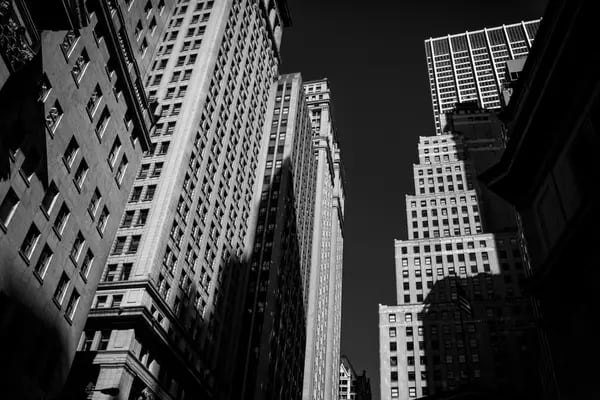 Buildings on Wall Street near the New York Stock Exchange (NYSE) in New York, US. Photographer: John Taggart/Bloomberg