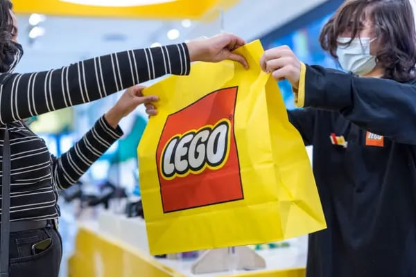A customer is handed their purchase at the Lego A/S store in London, U.K., on Monday, March 7, 2022. The Lego Group will report their annual results on Tuesday. Photographer: Jason Alden/Bloomberg
