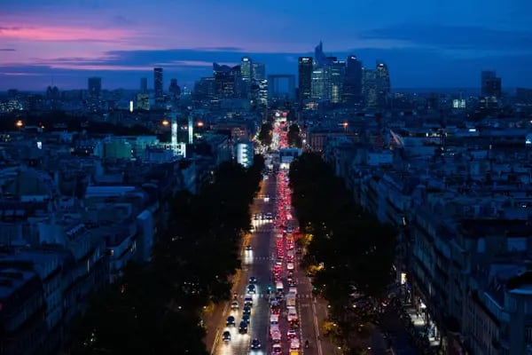 Traffic on Avenue de Neuilly in view of skyscrapers, in Paris, France.