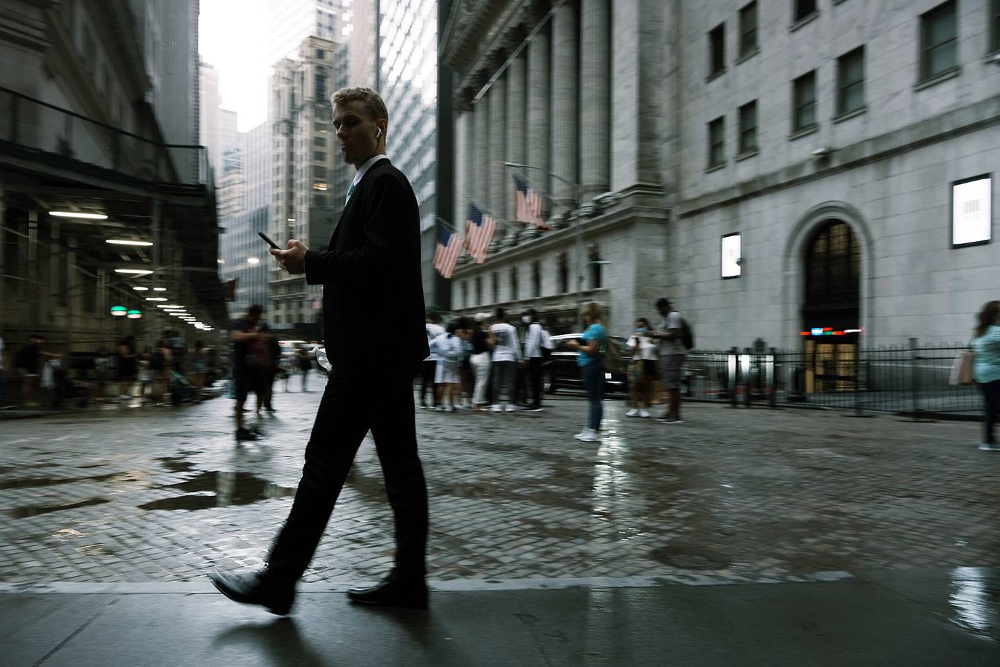 People walk along Wall Street, in New York City, U.S. (Photo by Spencer Platt/Getty Images)