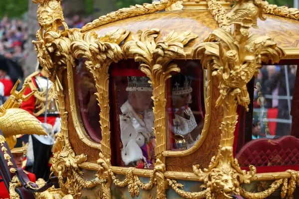 King Charles III, left, and Queen Camilla, travel along The Mall in the Gold State Coach, on the day of the coronation of King Charles III, in London, UK, on Saturday, May 6, 2023.