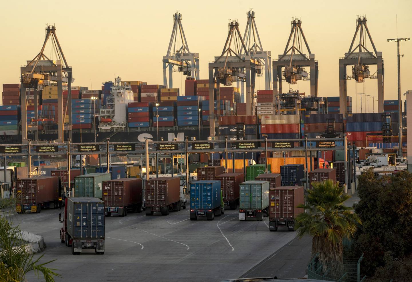 Camiones de carga que transportan contenedores en el puerto de Los Ángeles en octubre. La demanda de bienes podría enfriarse a medida que el estímulo de la pandemia se desvanezca o que el temor a unas condiciones financieras más estrictas erosione la confianza. Fotógrafo: Kyle Grillot/Bloombergdfd