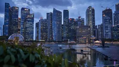 Buildings illuminated at dusk in the central business district (CBD) of Singapore, on Thursday, Jan. 28, 2021.