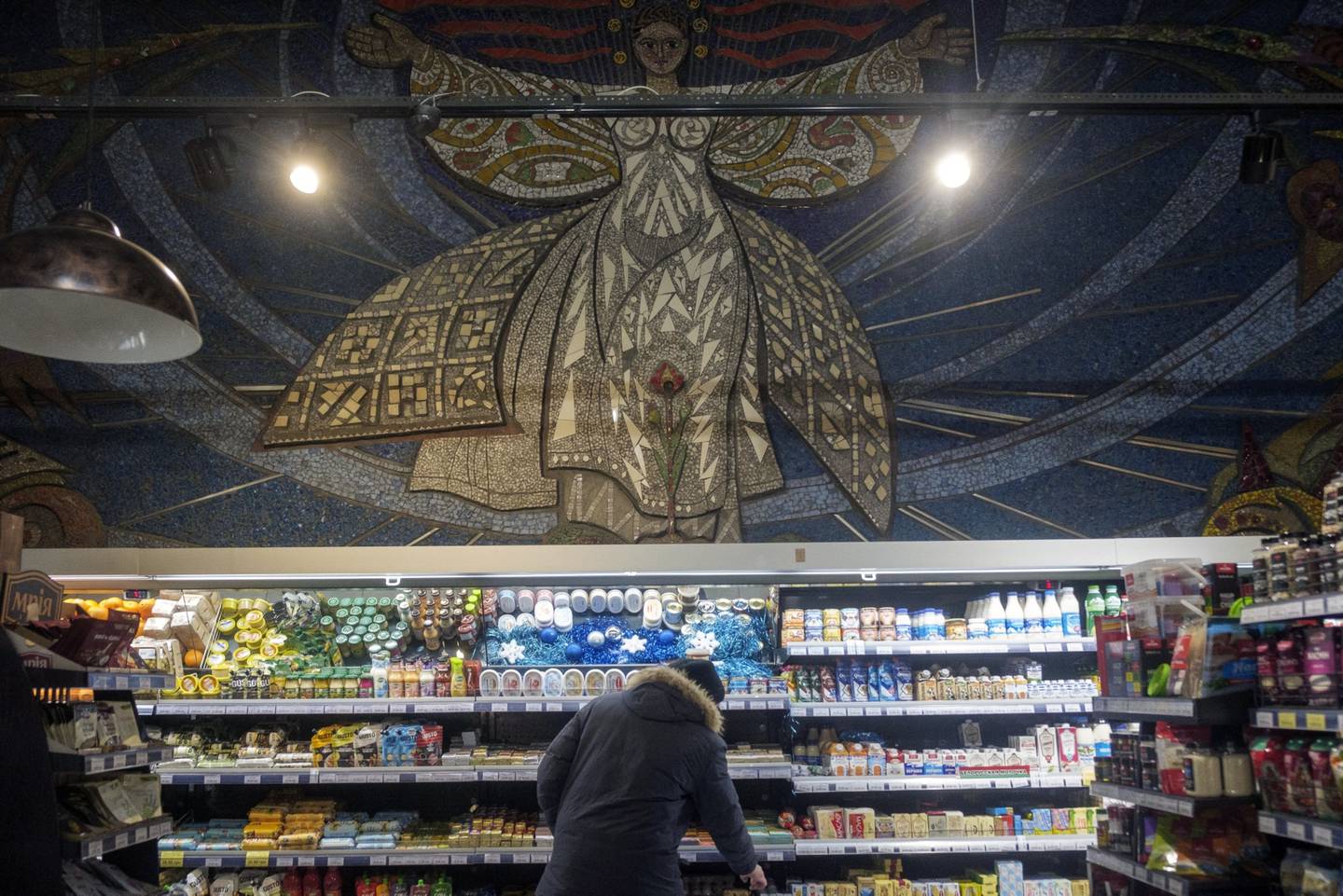 A Soviet era mosaic above an aisle of a grocery store in Mariupol.dfd