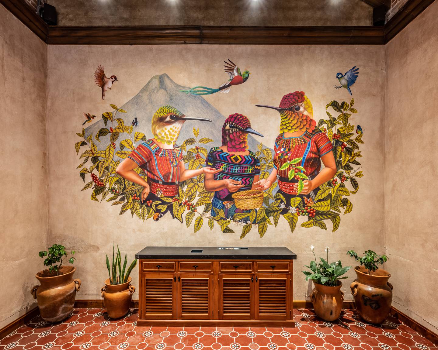 A work by Sololá, Guatemala-born artist Álvaro Tzaj Yotz that shows three women, represented by hummingbirds, feeding from a coffee plant and sharing coffee beans.