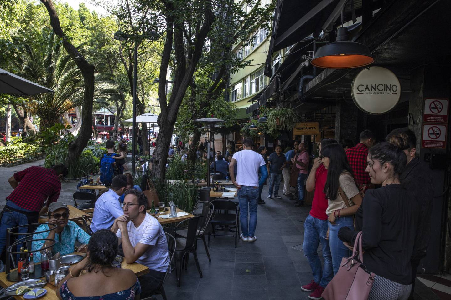 People sit outside a restaurant in the Roma neighborhood of Mexico City, Mexico, on Thursday, July 4, 2019. Photographer: Alejandro Cegarra/Bloomberg