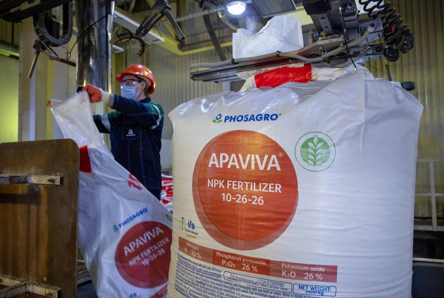 A worker operates a machine to fill sacks of Apaviva NPK(S) phosphate fertilizer at the PhosAgro-Cherepovets fertilizer plant, operated by PhosAgro PJSC, in Cherepovets, Russia, on Thursday, Dec. 2, 2021. Russia plans to impose a six-month quota on some fertilizer exports to safeguard local supplies and limit costs for farmers after the energy crisis sent nitrogen nutrient prices soaring. Photographer: Andrey Rudakov/Bloomberg