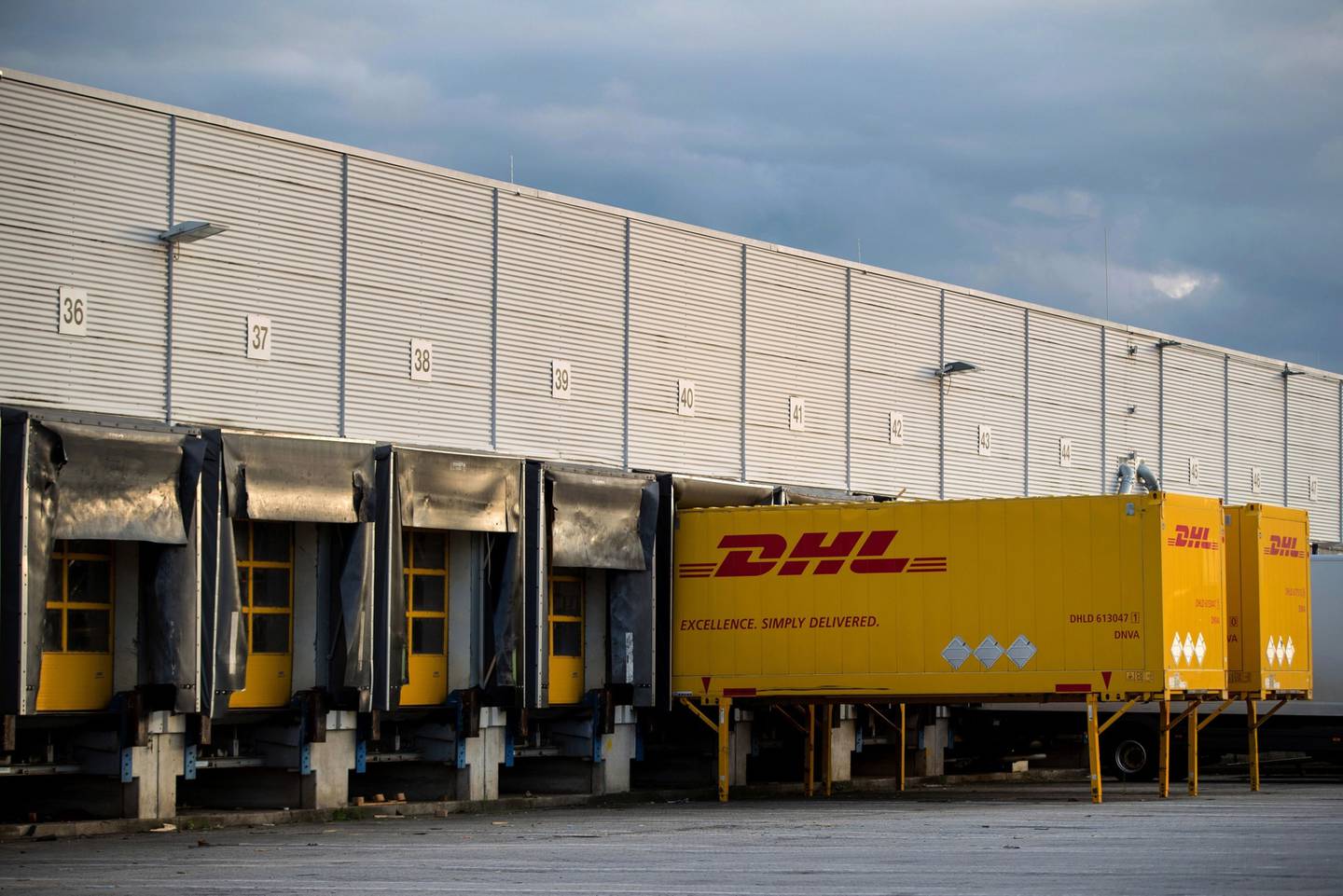 DHL delivery wagons in the loading bay at a Deutsche Post AG sorting office in Berlin, Germany.