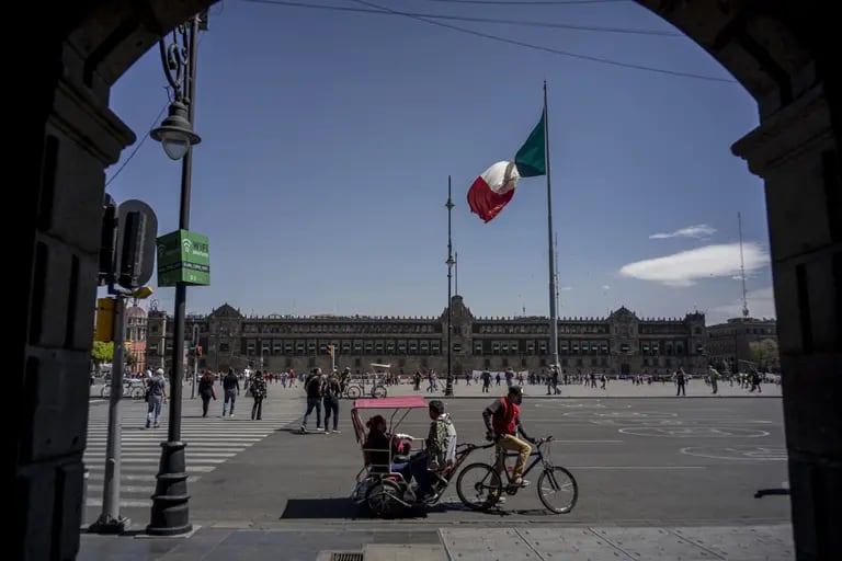 Un bicitaxi transporta a sus clientes en el Zócalo de la Ciudad de México.dfd