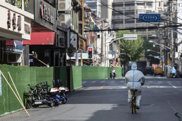 Un trabajador con equipo de protección personal (EPP) recorre una carretera durante un bloqueo debido al Covid-19 en Shanghái, China, el martes 3 de mayo de 2022. Fuente: Bloomberg