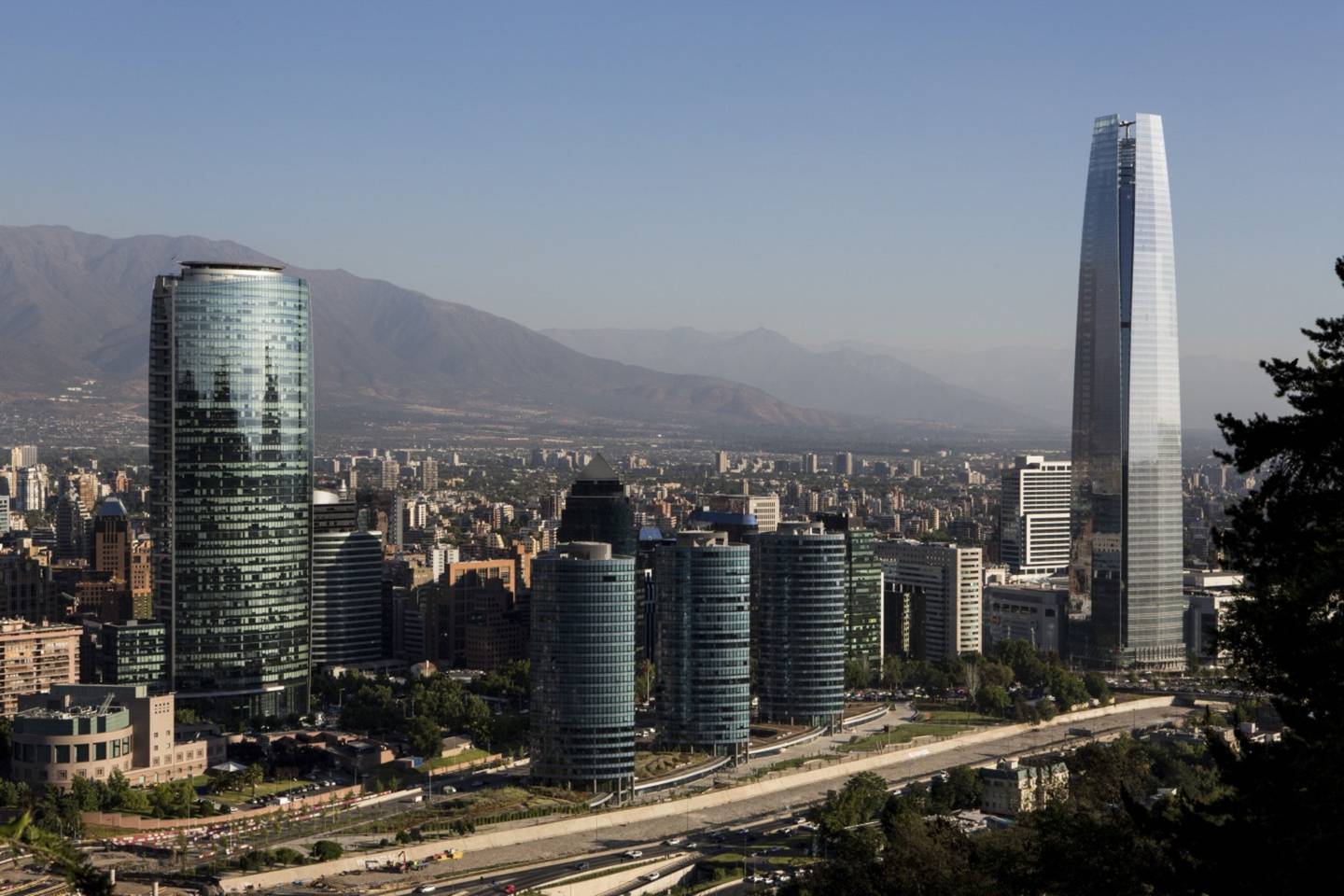 Buildings stand in the skyline of downtown Santiago, Chile, on Wednesday, Dec. 3, 2014. Chilean unemployment unexpectedly fell in the three months through October, the first month of a quarter that Finance Minister Alberto Arenas forecasts will see a "small and moderate reactivation" in the economy. Photographer: Ronald Patrick/Bloomberg